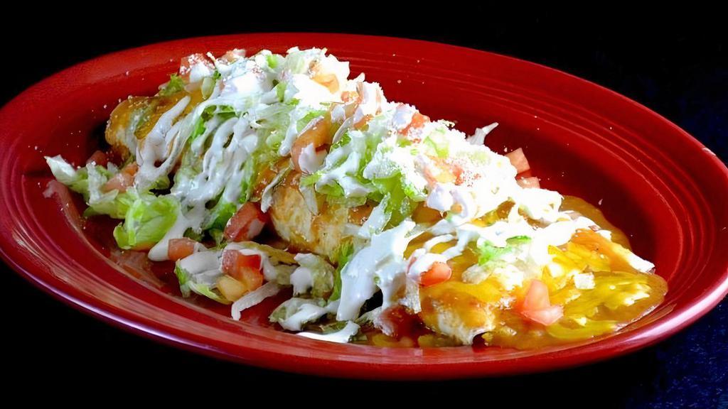 Macho Burrito · A super flour tortilla filled with rice, beans and choice of ground beef, chicken or picadillo. Smothered with burrito sauce and topped with Cheddar cheese, lettuce, tomatoes, crema Mexicana and Cotija Mexican cheese