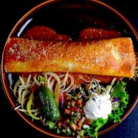 Carne Asada Burrito · 12 Inch flour tortilla stuffed with tender skirt steak, refried beans and Mexican rice. Topp...