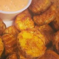 Fried Pickles · Seasoned battered butter pickle chips served with a ranch dipping sauce