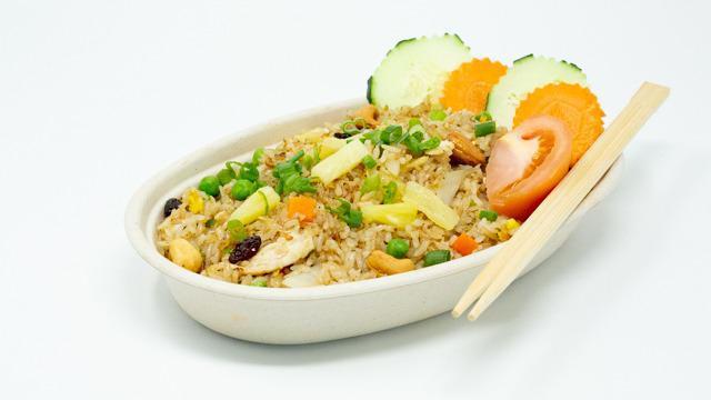Pineapple Fried Rice · Stir-fried rice with scallions, tomatoes, carrots, raisins, cashew nuts, pineapples, and egg.