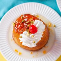 Rum Cake  · Rum Baba. Topped with whipped cream.