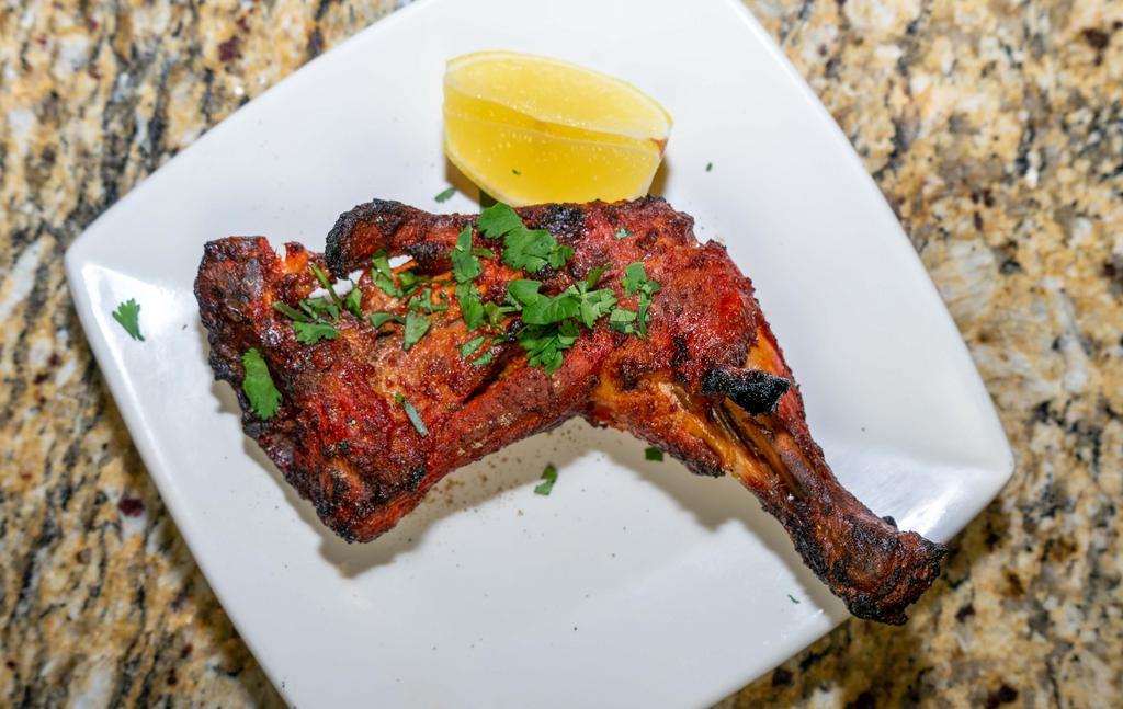 Chicken Leg Quarter · Marinated with yogurt, herbs and spices finished in a clay oven served with mint and tamarind chutneys.