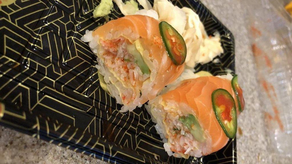 Sumo Roll · Inside spicy kani and avocado. Outside salmon and jalapeno with soy bean paper.