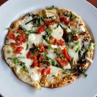 Caprese Flatbread · Roasted garlic, mozzarella duo, sun-dried tomatoes, and fresh basil.