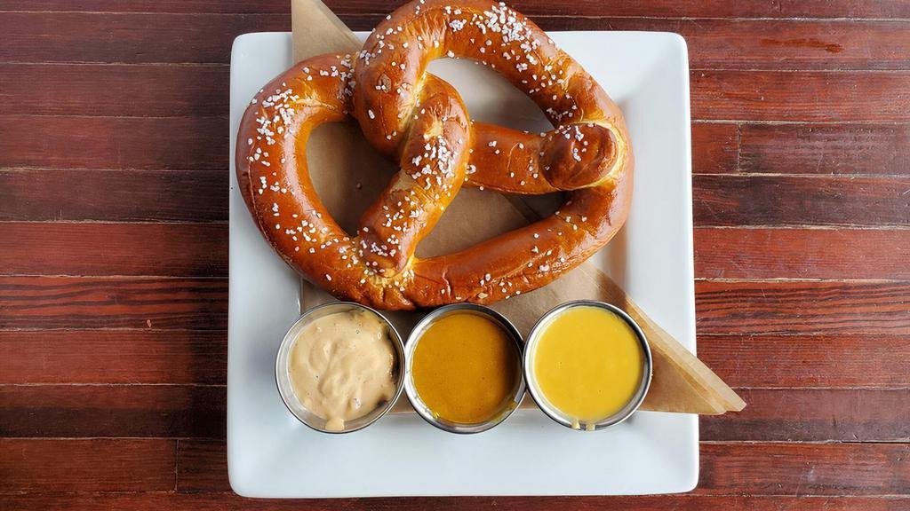 House Baked Pretzel · Freshly baked pretzel with Redmond's cheese sauce, honey mustard, and chipotle aioli.