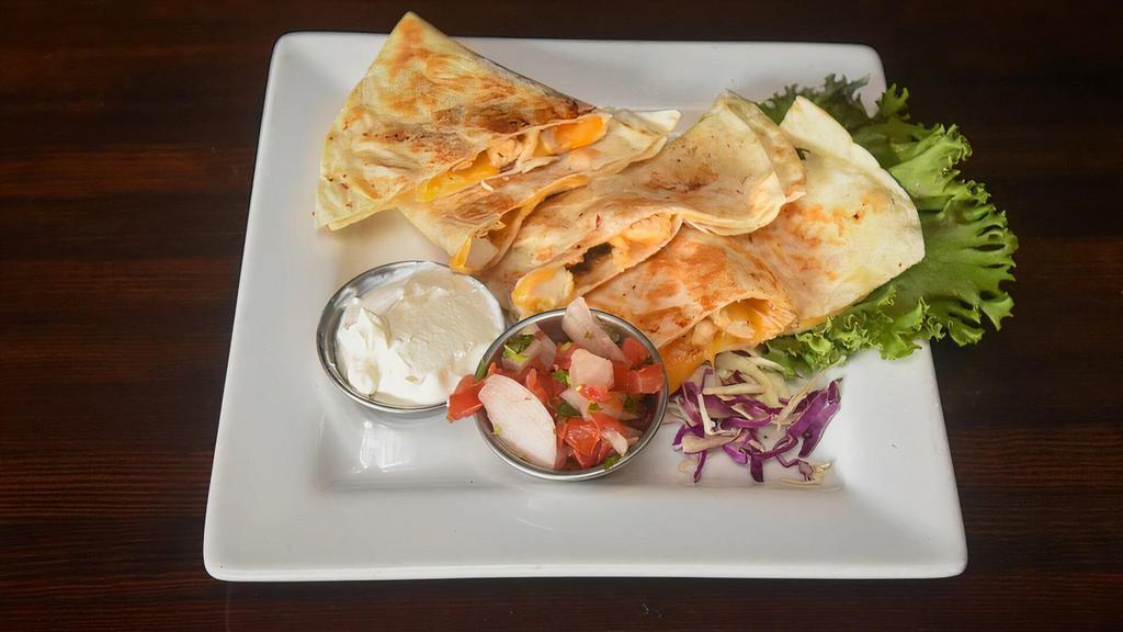 Chicken Quesadilla · Chicken, cheddar-jack cheese and smoked onions in a flour tortilla. Served with pico de gallo and sour cream.