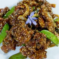 Sesame Beef · Spicy. Battered fried beef slices, stir-fried in a savory spicy sauce with sesame seeds, oni...
