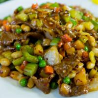 Kung Pao Beef · Spicy. Tender beef stir-fried with fresh onions, bell peppers, carrots, peas, and peanuts in...