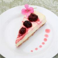 Raspberry Cheesecake · Classic cheesecake with a rich, dense, smooth, and creamy consistency topped with fresh rasp...