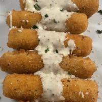 Fried Mozzarella · Golden crispy fried mozzarella stick drizzled with Alfredo sauce and paired with marinara.