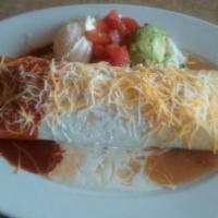 Burrito Grande · Large flour tortilla filled with shredded beef, ground beef, chicken, refried beans and rice...