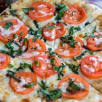 Margherita · Hand-made crust basted in virgin olive oil. Topped with fresh mozzarella, vine-ripe sliced t...