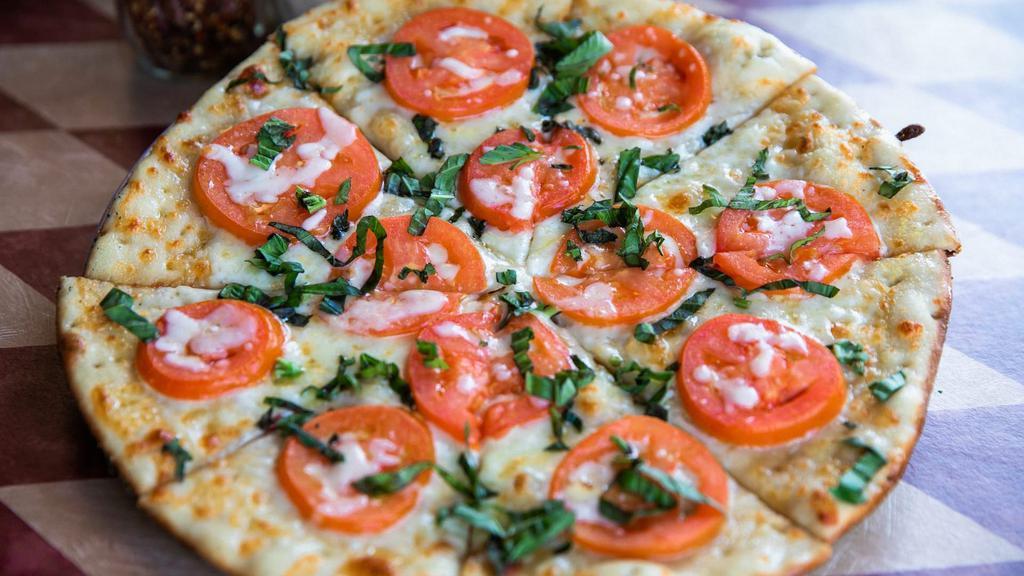 Margherita (Gf) · Gluten-free crust basted in virgin olive oil and topped with fresh mozzarella, vine-ripe sliced tomatoes, and freshly chopped basil leaves.