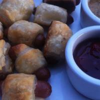 Piglets In A Blanket · Pastry wrapped smoked sausages BBQ-honey mustard.