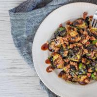 Crispy Balsamic Brussel Sprouts · Balsamic glaze, spiced pecans