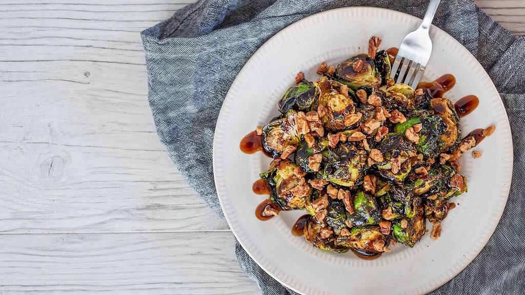Crispy Balsamic Brussel Sprouts · Balsamic glaze, spiced pecans