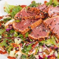Ahi Tuna Salad · Blackened & sesame seed crusted Ahi tuna, romaine, cabbage, pickled cucumbers, wasabi vinaig...
