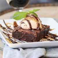 Triple Chocolate Brownie · Vanilla ice cream, warm fudge, caramel sauce