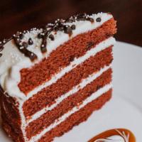 Red Velvet Cake · Four layers of red velvet cake filled with chocolate truffle ganache, cocorum caramel, tangy...