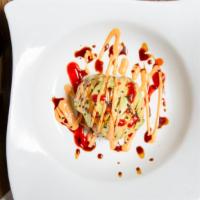 Monkey Brain · Spicy tuna, seaweed salad wrapped with avocado spicy sauce on top.