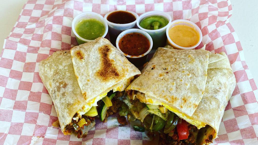 Breakfast Burrito · Choice of meat or vegetarian with scrambled eggs, potatoes, sour cream and cheese wrapped in a flour tortilla.