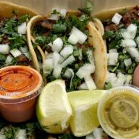 Street Tacos · Choice of meat. Topped with cilantro and onions served on a corn tortilla.