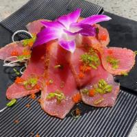 Tuna Tataki · Raw. Thinly sliced seared tuna, scallions, masago, and ponzu sauce.