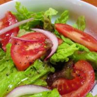 House Salad · Romaine Lettuce, Tomatoes, Onions, Olives & Oregano.