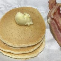 Pancake Plate · Choice Between Bacon/Sausage with three buttermilk pancakes, butter, and maple syrup.