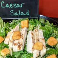 Chicken Caesar Salad · Romaine lettuce, Chicken, Parmesan, Croutons and Caesar dressing on the side.