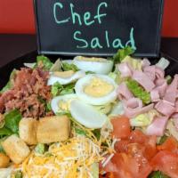Chef Salad · Romaine lettuce, ham, bacon, boiled egg, cheese, tomato, and croutons.  Choice of Ranch, Cae...