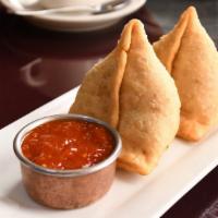 Vegetable Samosa · Crispy pastries stuffed with potatoes and peas, lightly seasoned with spices.