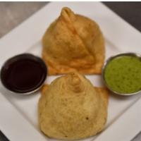 Lamb Samosa · Crispy pastries stuffed with lean ground lamb and peas, lightly seasoned with spices.