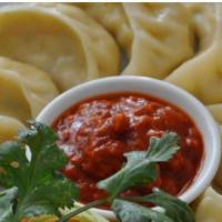 Vegetable Momo · A traditional delicacy of Nepal these vegan appetizers are a type of steamed dumplings consi...