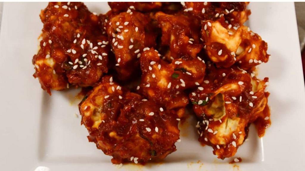 Gobi Manchurian · Not gluten-free. A classic Indo-Chinese specialty of lightly battered, marinated cauliflower sautéed with garlic chili, and soy sauce.