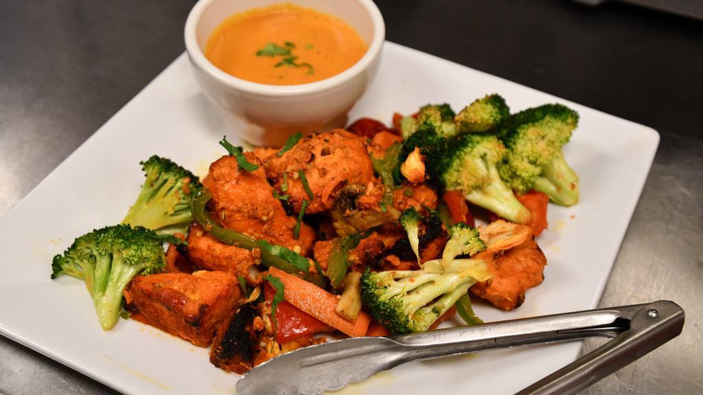 Chicken Tikka · Chicken marinated in tandoori spices and grilled in the tandoori oven on a skewer.