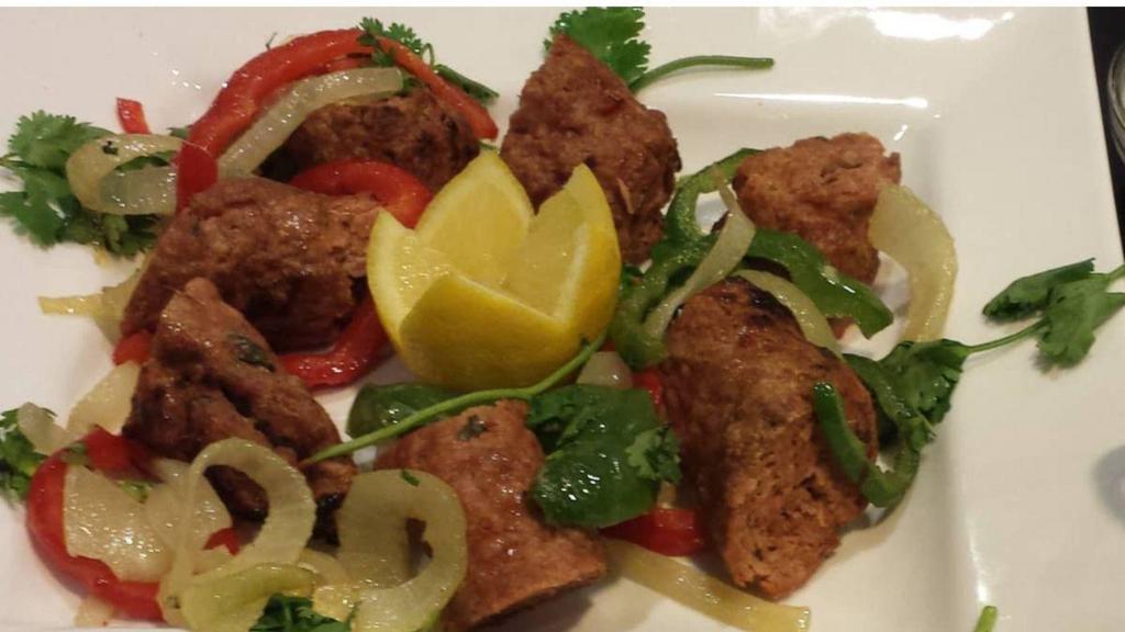 Seekh Kebab · Lean ground lamb marinated in chef's special sauce, fire-roasted on skewers. Served with dal or vegetable curry.
