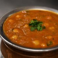Chana Masala (Chole) · Garbanzo beans cooked with a blend of spices, fresh tomatoes, onion, ginger and garlic.