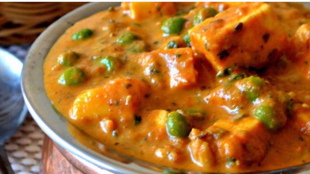 Matar Paneer · Fresh homemade Indian cheese and fresh green peas cooked with tomatoes, onions, and herbs.