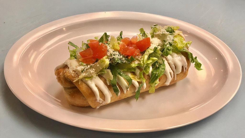 Chimichanga · Served with beans, cheese, sour cream and guacamole, lettuce, dry cheese and tomatoes on the top.