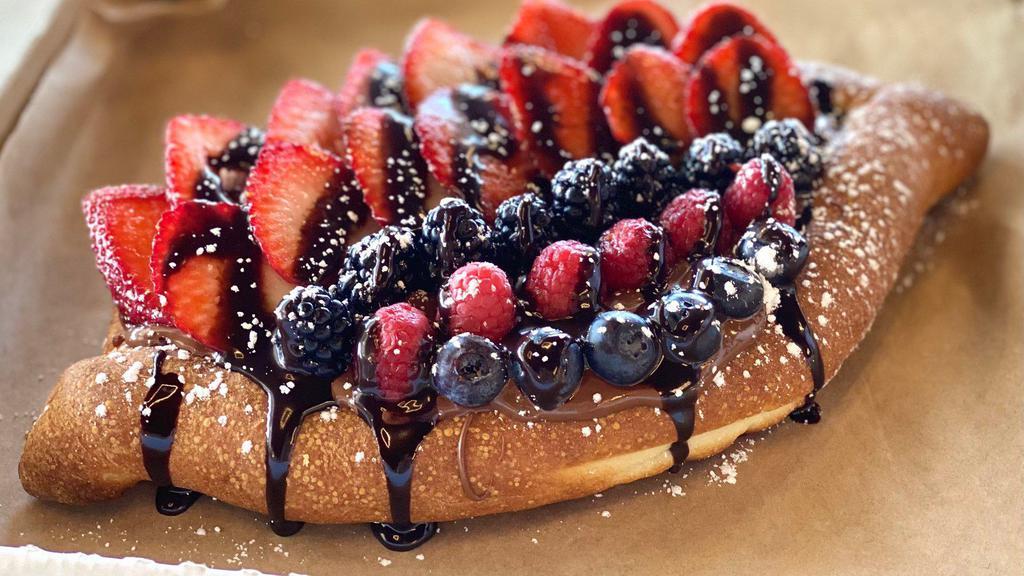 Ajarski Khachapuri With Nutella/Fruit · A baked bread with a load of Nutella, topped with various fruit, sprinkled with powdered sugar and drizzled in chocolate syrup.