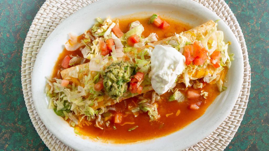 Burrito Macho · Flour tortilla filled with your choice of pork, chicken, beef, or shredded beef, rice, and beans, topped with Spanish sauce, lettuce, cheese, guacamole, and sour cream.