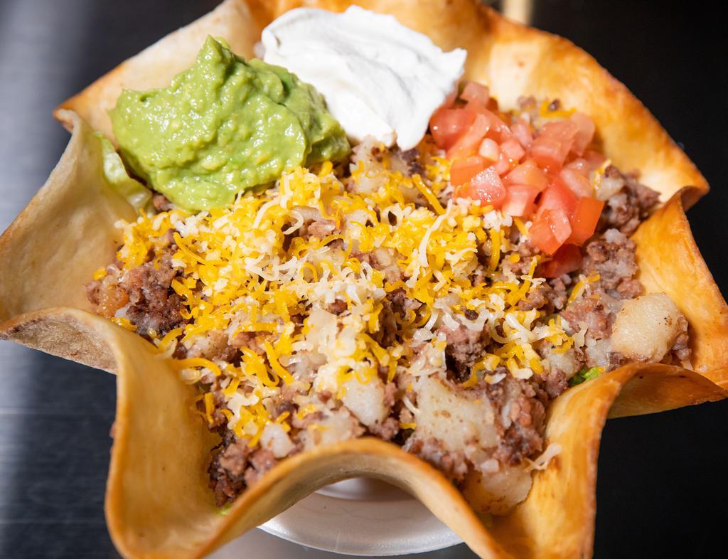 Taco Salad · CHOICE OF MEAT IN DEEP FRIED TORTILLA SHELL, LETTUCE, TOMATO, CHEESE, SOUR CREAM, GUACAMOLE AND SALSA.