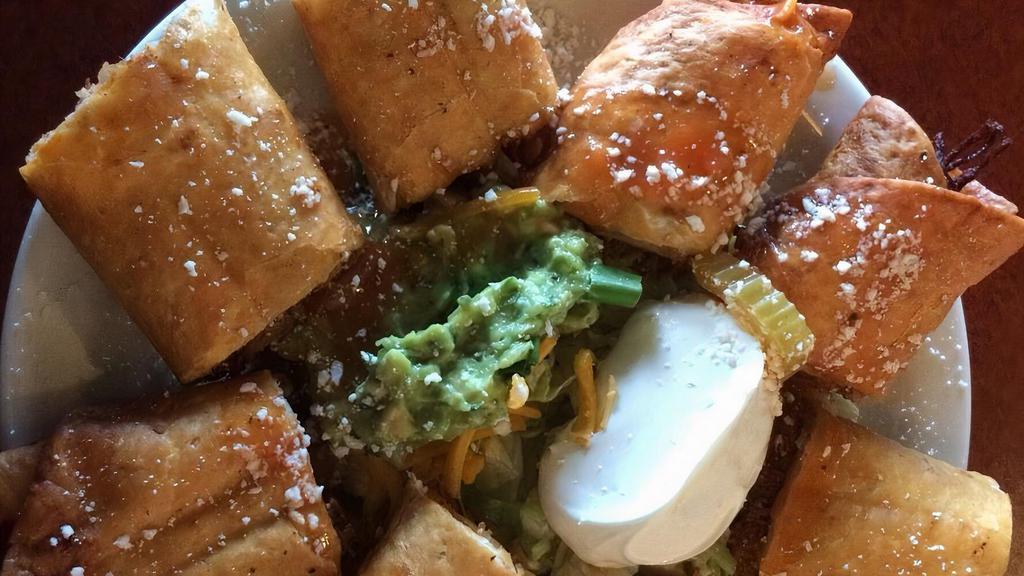 Taquitos · Flour tortilla deep fried with choice of chicken or picadillo. Topped with onions, tomatoes, sour cream, and guacamole.