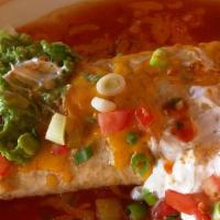Macho Burrito · Flour tortilla filled with rice and beans. Topped with burrito sauce, onions, tomatoes, sour...