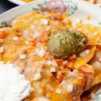 Casa Alegre Nachos · Gluten-free. House nachos topped with refried beans, jack and cheddar cheese, tomato, onion,...