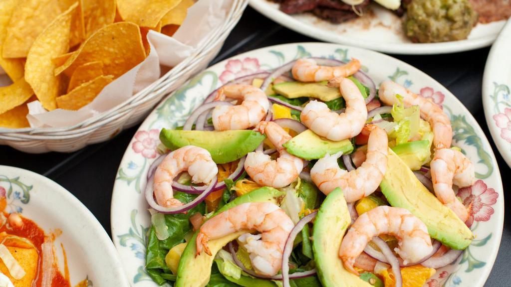 Puerto Vallarta Salad · Gluten-free. Cooked shrimp, spinach, romaine lettuce, cucumber, tomato, red onion, orange, sliced avocado, mango, seasoned with citrus vinegar.