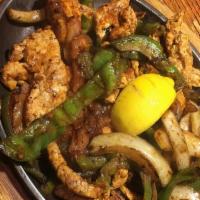 Sizzling Fajitas · Gluten-free. Steak, pork or chicken delivered in a sizzling hot dish over a bed of sautéed o...