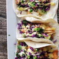 Jackfruit Tacos · A warmed tortilla with chili lime jackfruit, cilantro sauce, melted cheese, and our house ma...