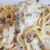 Spaghetti Carbonara · Sautéed pancetta & diced onions in a creamy egg cheese sauce.